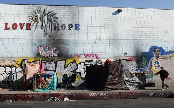 A person walks past a homeless encampment in the Skid Row community on Sept. 28, 2023, in Los Angeles. (Mario Tama/Getty Images/TNS)