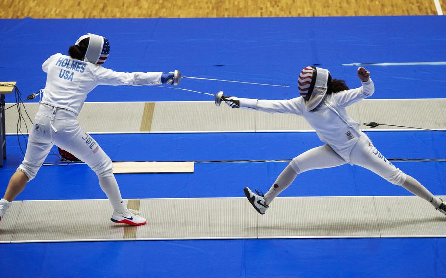 Katharine Holmes, left, an epee fencer for the U.S. women’s Olympic team, spars with junior athlete Lola Constantino inside Lotus Culture Center Arena at the Atago Sports Complex in Iwakuni, Japan, July 16, 2021. 