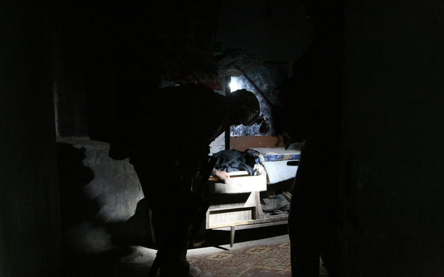 Capt. Eric Melloh, 30, of Huntsville, Texas and commander of  Company A, 1-30th Infantry, 2nd Brigade, 3rd Infantry Division, searches the home of a man suspected of helping insurgents direct mortar fire at Forward Operating Base Murray in Iraq’s Arab Jabour district southeast of Baghdad.