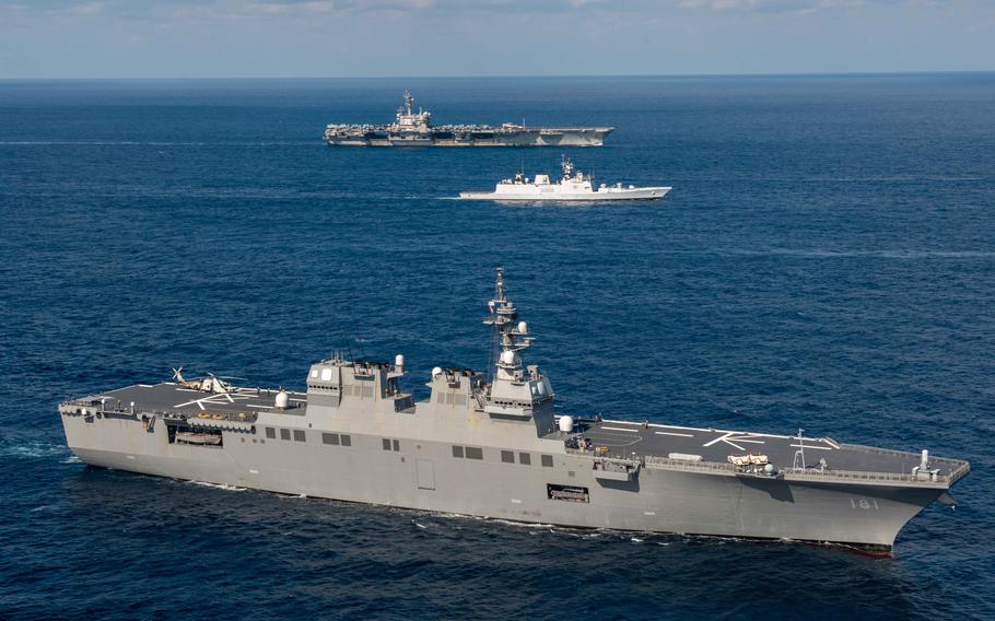 The Japanese destroyer JS Hyuga steams in formation with the Indian frigate Shivalik and the aircraft carrier USS Ronald Reagan in the Philippine Sea during Exercise Malabar Nov. 11, 2022. 