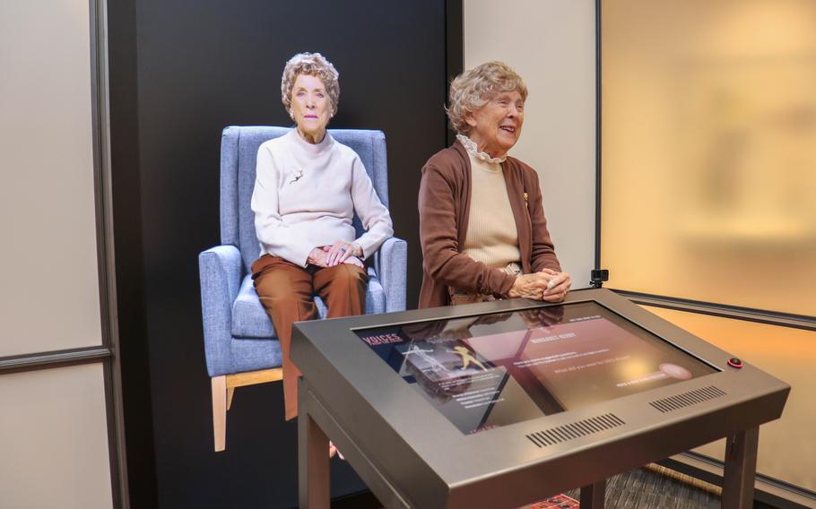 Former USO dancer Margaret Kerry-Boeke, who sat for two days of interviewers and answered nearly 1,000 questions on camera, stands with her video image at the Voices From the Front exhibit at the National WWII Museum in New Orleans. 