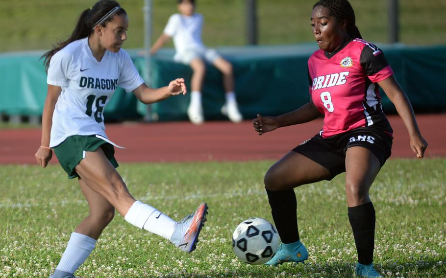 Kubasaki's Syra Soto sends the ball past Kadena's Kaya Castle during Wednesday's DODEA-Okinawa soccer match. The Panthers won 3-1.