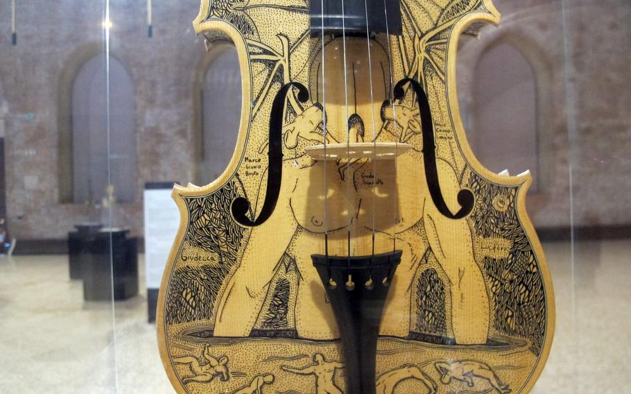 A depiction of Lucifer trapped in ice in the center of the lowest level of hell is one of 34 stringed instruments making up an art exhibit in Vicenza, Italy based on Dante's "Divine Comedy." "Infernus" runs through Aug. 31.