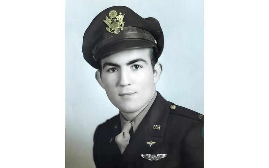 A vintage photo from World War II showing an Army Air Forces lieutenant posing in uniform for a photo portrait.