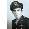 A vintage photo from World War II showing an Army Air Forces lieutenant posing in uniform for a photo portrait.