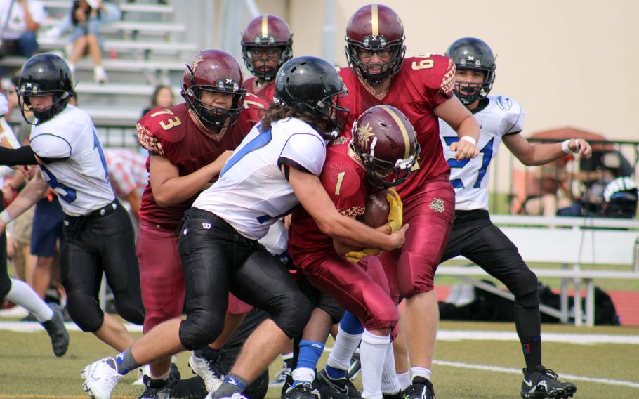 Osan's Asher Horne wraps up Matthew C. Perry's Jacob Cerros.
