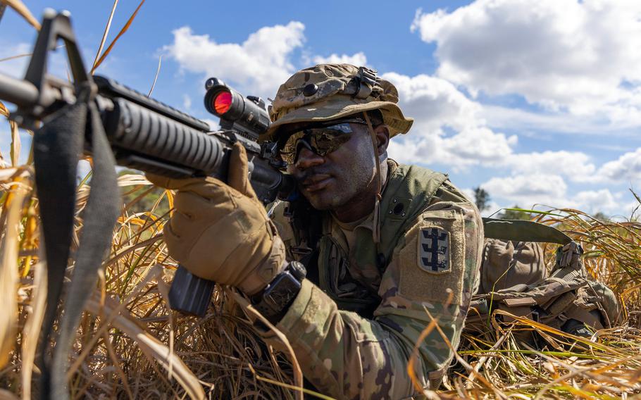 A soldier shoulders a rifle at Schofield Barracks, Hawaii, Nov. 2, 2023, during the Joint Pacific Multinational Readiness Center exercise.