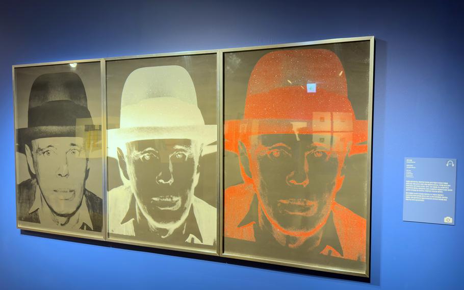 A painting shows three images of the same man in different colors.