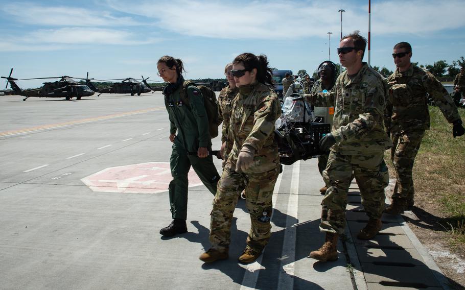 American and Polish service members retrieve mock casualties Romania during the Saber Guardian exercise June 6, 2023, at Mihail Kogalniceanu Air Base in Romania.