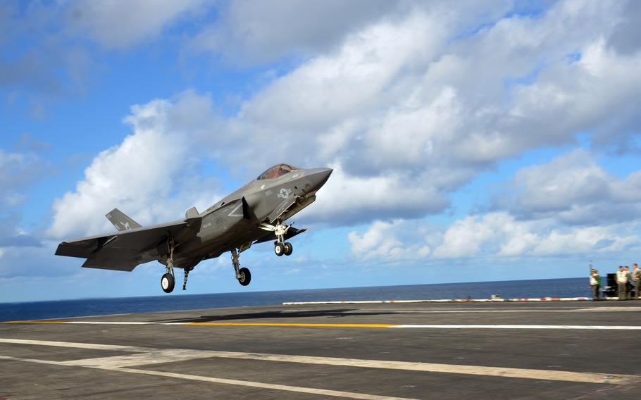 An F-35C Lightning II stealth fighter lands aboard the aircraft carrier USS Carl Vinson in the Philippine Sea, Tuesday, Nov. 30, 2021. 