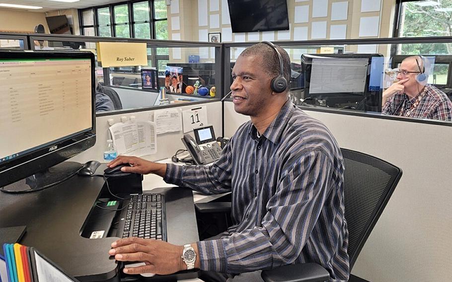 Roy Suber, an education counselor with the Navy College Virtual Education Center in Virginia Beach, Va., assists a sailor over the phone on Sept. 23, 2021. 