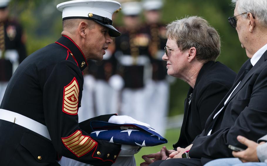 Marine Corps Sgt. Maj. Carlos A. Ruiz presents a folded flag to Cheryl Cronin, niece of Pfc. Lawrence Earl Garrison, during a service at Arlington National Cemetery on Thursday.