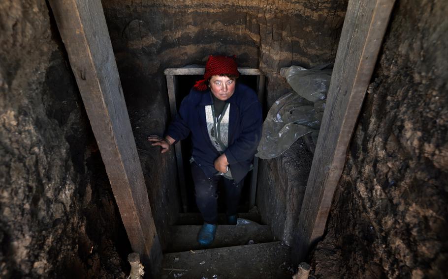 Natasha Romanovskia stands at the entrance to the village bunker in Shyroke, Ukraine, which was liberated from the Russians. She and her husband, Victor Romanovskia, stayed in their home, which is now badly damaged and has no heating.