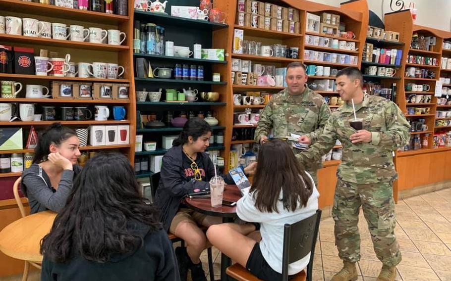 U.S. Army recruiting students talk with potential recruits during an exercise in Chicago, July 17, 2019. The Army is now offering recruits a guaranteed first assignment at select posts.