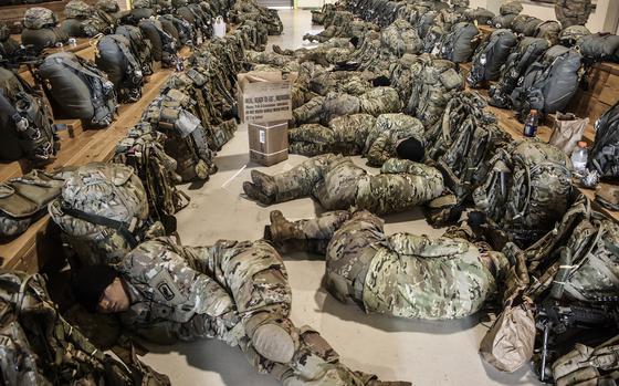 Paratroopers from the 173rd Airborne Brigade sleep on the floor after working through the evening prior to an early-morning combat equipment jump at Aviano, Italy, on March 17, 2018.