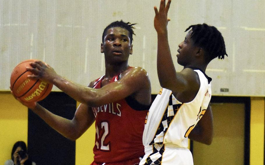 Kinnick's Nicholas Whyte looks for room against Kadena's Cedric Dorelein.