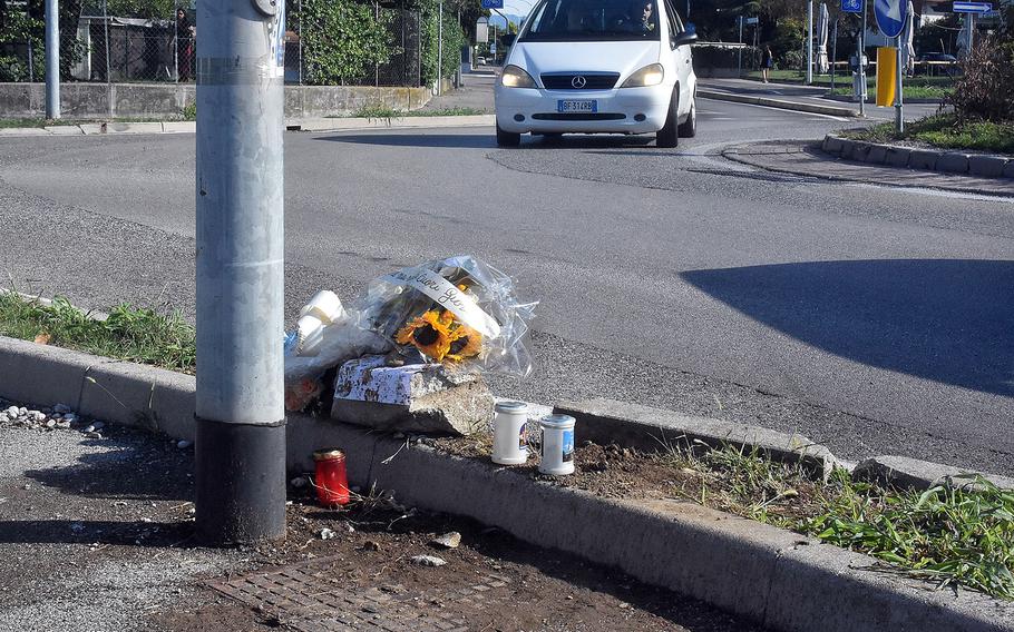 A car passes through a roundabout in the Italian town of Sant' Antonio where an Italian teenager was killed early Sunday, Aug. 21, 2022. An American airman assigned to Aviano Air Base was driving the car that left the road and struck the pedestrian walking in the bike lane, according to Italian media reports.