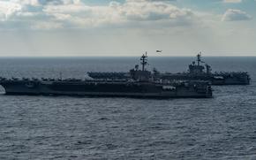 The aircraft carriers USS Carl Vinson, front, and USS Abraham Lincoln transit the Philippine Sea on Jan. 22, 2022.