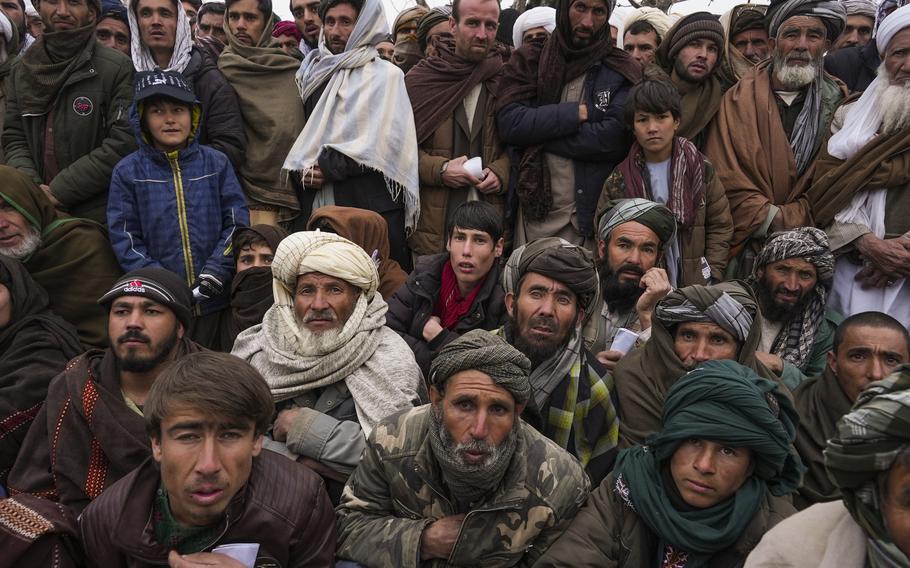 Hundreds of Afghan men gather to apply for the humanitarian aid in Qala-e-Naw, Afghanistan, Tuesday, Dec. 14, 2021. In a statement Tuesday, Jan. 11, 2022, the White House announced $308 million in additional humanitarian assistance for Afghanistan, offering new aid to the country as it edges toward a humanitarian crisis since the Taliban takeover nearly five months earlier.