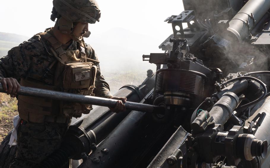 Marine Corps Lance Cpl. Aliyor Rashidov with 3d Battalion, 12th Marines, 3d Marine Division, clears an M777 towed 155 mm howitzer during an artillery relocation training program at the Japan Ground Self-Defense Force Hijudai Training Area, Japan, April 16, 2022. 