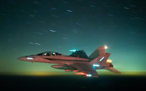 A U.S. Navy F/A-18 Super Hornet flies against a dark greenish blue sky. 