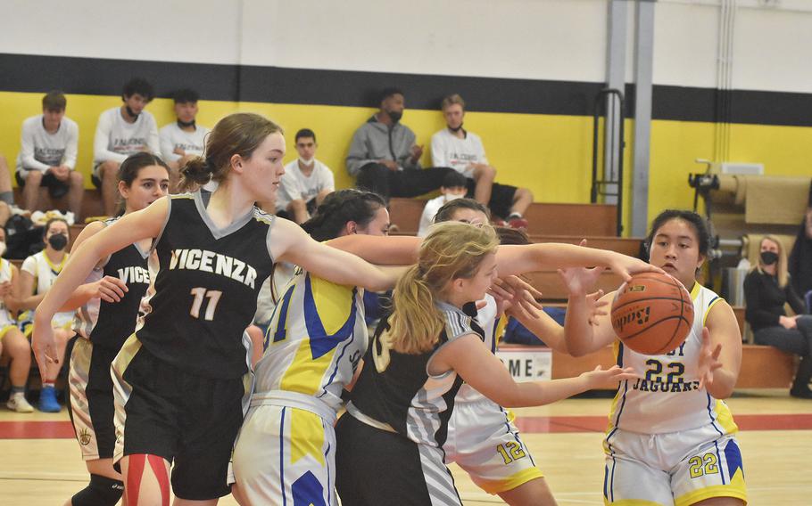 Vicenza and Sigonella girls basketball players battle for the elusive basketball Thursday, March 3, 2022, on the opening day of the DODEA-Europe Division II basketball championships in Vicenza, Italy.
