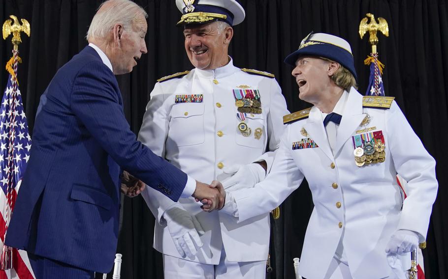 President Joe Biden shakes hands with Adm. Linda Fagan, commandant of the U.S. Coast Guard, during a change of command ceremony at U.S. Coast Guard headquarters in Washington, D.C., on Wednesday, June 1, 2022. Adm. Karl L. Schultz, center, was relieved by Fagan, who is the first female service chief in U.S. military history. 