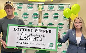 A man and woman hold a large check denoting a value of $1,351,472.