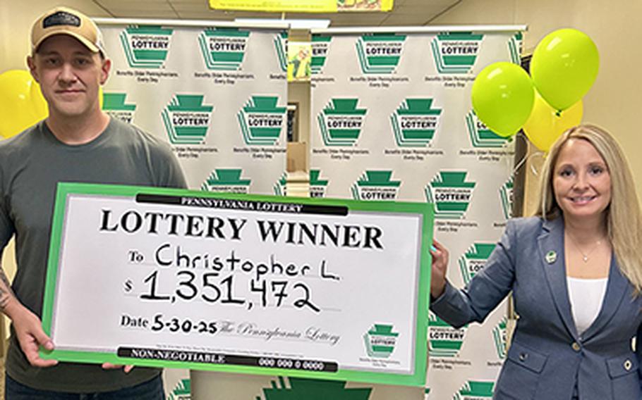 A man and woman hold a large check denoting a value of $1,351,472.
