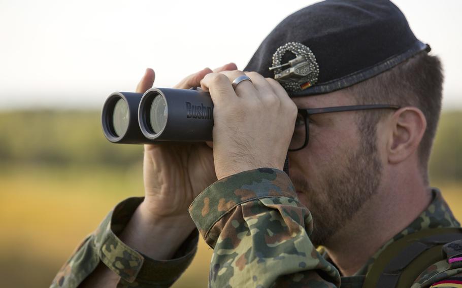 A German soldier watches Ukrainian special operations forces during Exercise Rapid Trident at Yavoriv, Ukraine in 2017. Germany offered to send 5,000 helmets to Ukraine, but no weapons. About 70% of Germans oppose sending arms to Ukraine, according to a new poll.