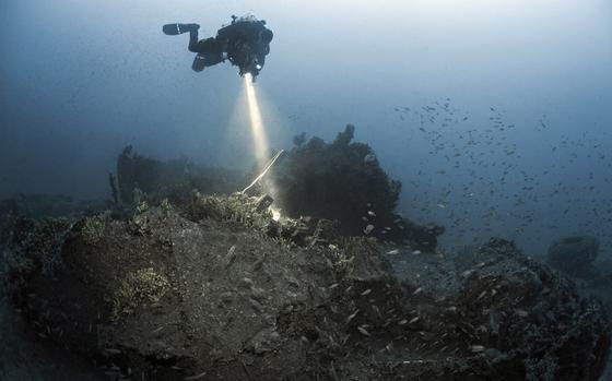 A diver searches for clues to the identity of a World War II-era B-24 bomber lying in waters off the coast of Croatia during a two-week search mission in August 2022.