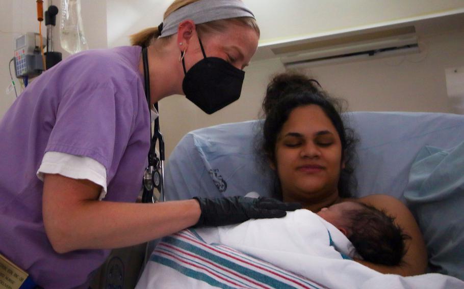 Allison Haberstroh, a labor and delivery nurse at Landstuhl Regional Medical Center, Germany, checks vital signs of Airman 1st Class Ariana Aponte Rodriguez at LRMC on Sept. 9, 2021. LRMC staff has delivered 18 babies of mothers who evacuated from Afghanistan since Aug. 20, 2021. The Army hospital also continued to care for its military population while supporting evacuees at nearby Ramstein Air Base and Rhine Ordnance Barracks.