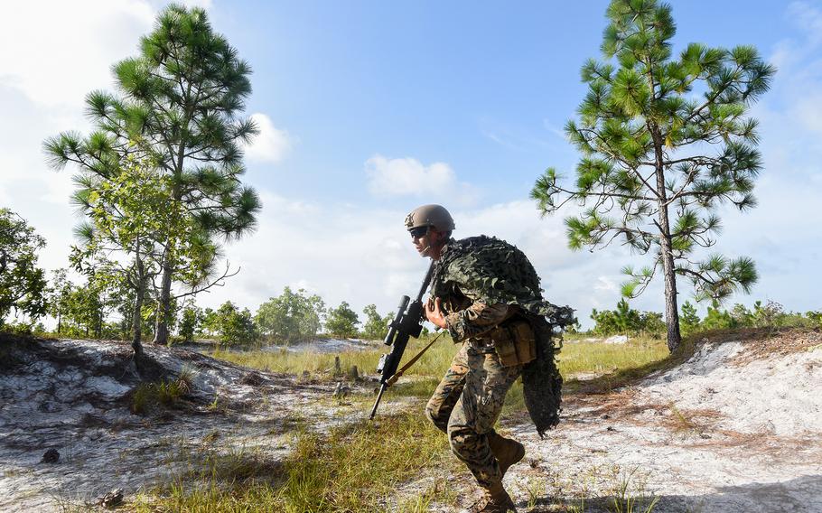 A Marine infantry student at Camp Lejeune, N.C., practices setting up an ambush in a live-fire training event Aug. 27, 2021, during their 12th week of initial infantry training as part of a pilot program meant to drastically change the way the Corps trains its infantrymen. The pilot program expands infantry training from nine to 14 weeks and places Marines in 14-person squads under a single instructor.