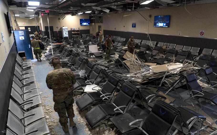 U.S. Air Force airmen from the 405th Expeditionary Support Squadron work to clear debris inside the passenger terminal at Bagram Airfield, Afghanistan, following a Taliban-led attack, Dec. 12, 2019. 