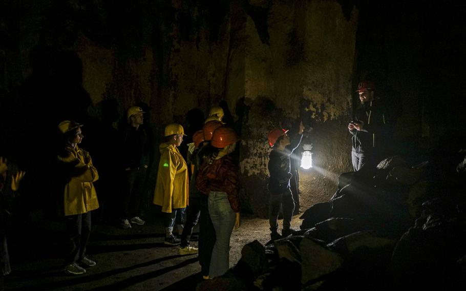 A tour guide leads visitors through the Mendig Lava Caverns on Sept. 21, 2024, in Mendig, Germany. The caverns, formed by ancient lava flows, were used for basalt mining and later beer storage, and now serve as a historical attraction.