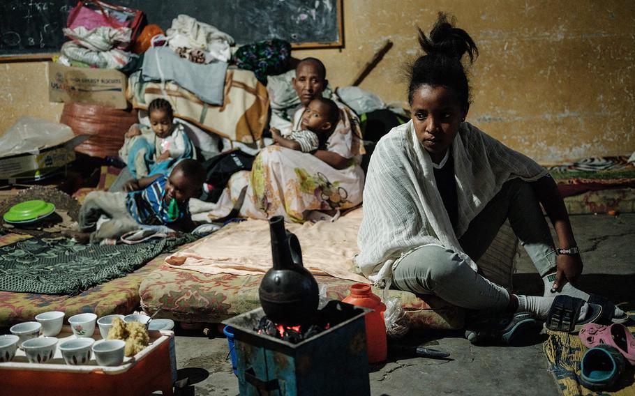 A woman who fled from the conflicts in Ethiopia’s violence-hit Tigray region prepares coffee in a classroom occupied with 25 mothers for more than seven months at an elementary school in Mekele, the capital of Tigray region, Ethiopia, on June 18, 2021.