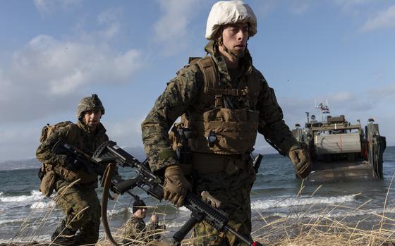 Marines participate in a multinational amphibious landing in Sandstrand, Norway, on March 21, 2022, as part of the Cold Response military exercise. 