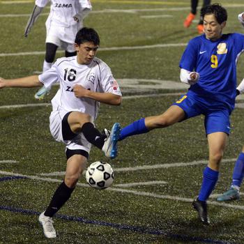 Zama American's Chris Jones and Yokota's Landon Reyes tangle for the ball during Friday's DODEA-Japan boys soccer season opener at Yokota's Fred Bonk Memorial Field. The Trojans won 1-0, their first victory over the Panthers in four years.