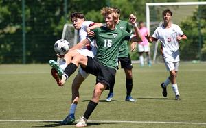 Naples midfielder Colin McCord and American Overseas School of Rome winger Ghione Federico fight for possession during the first day of pool-play action at the 2025 Division II DODEA European championships at the stadium of VfB Reichenbach on May 19, 2025, in Reichenbach-Steegen, Germany.