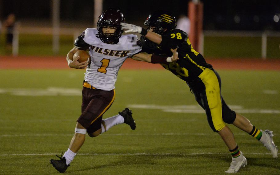 Vilseck’s Gabriel Morell tries to stay out of the grip of Stuttgart’s Levi Katzenberger in the DODEA-Europe Division I football championship game at Kaiserslautern, Germany, Oct. 29, 2022. Stuttgart won 51-12.