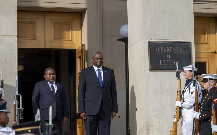 Defense Secretary Lloyd Austin and Mozambique President Filipe Nyusi stand for the playing of the U.S. and Mozambiqua national anthems at the Pentagon on Friday, Sept. 22, 2023.