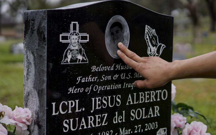 Erik Suarez del Solar visits the grave of his father, Marine Lance Cpl. Jesus Suarez del Solar, at Oak Hill Memorial Park in Escondido, Calif. Jesus Suarez del Solar was killed in combat in Iraq in 2003. 