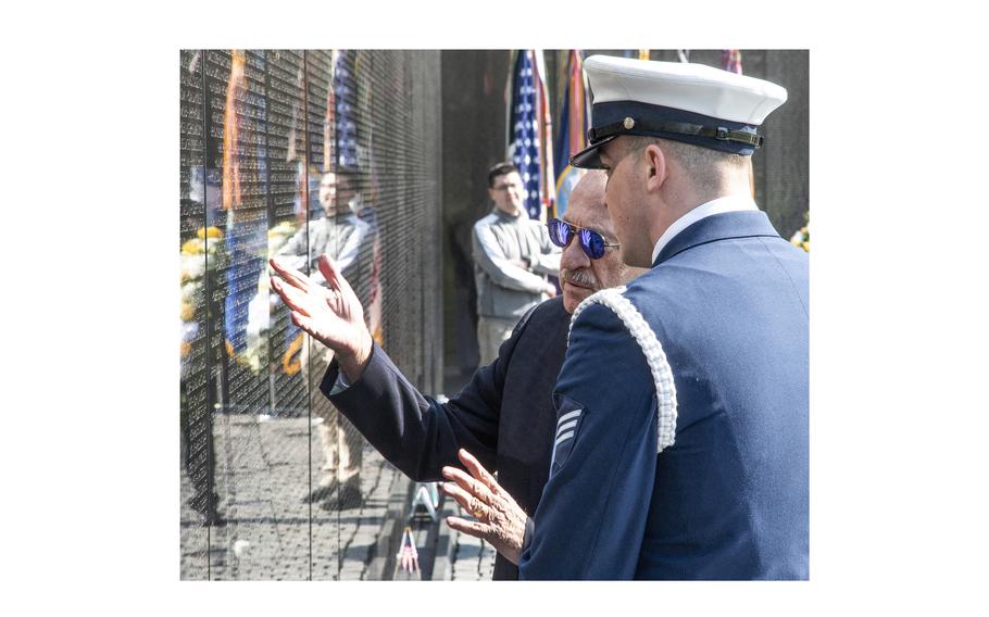 Jan Scruggs, retired head of the Vietnam Veterans Memorial Fund and the driving force behind the construction of the Vietnam Veterans Memorial, explains details about the Wall to his Coast Guard escort, Seaman Tommy Howard, during a National Vietnam War Veterans Day wreath-laying ceremony in Washington, D.C., March 29, 2024.