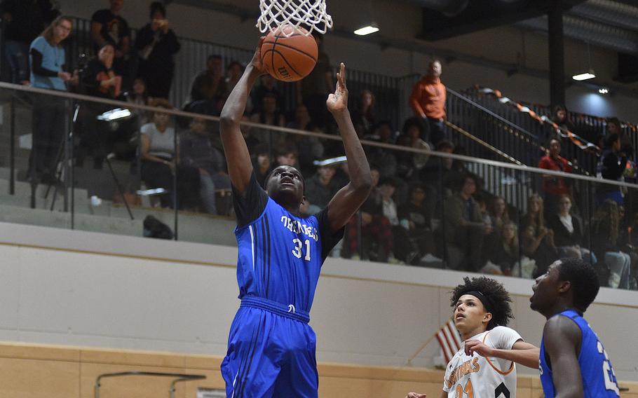 Hohenfels' Joel Idowu goes up for a dunk during a basketball game on Jan. 26, 2024, at Spangdahlem High School in Spangdahlem, Germany.