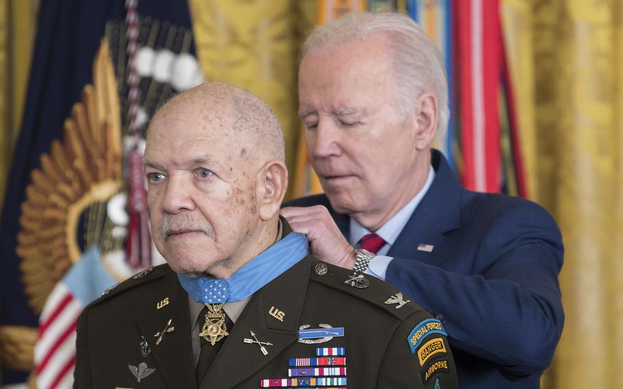 President Joe Biden fastens a Medal of Honor on Retired Army Col. Paris Davis during a ceremony at the White House on Friday March 3, 2023.