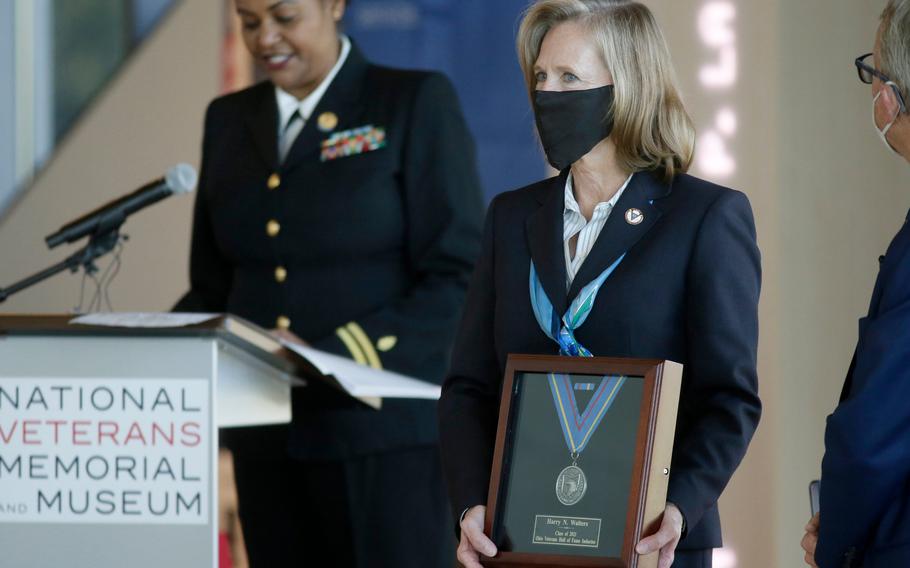 Ohio Department of Veterans Services Director Deborah Ashenhurst holds up the medal for Harry N. Walters (U.S. Army/USAR), who was posthumously inducted into the Ohio Veterans Hall of Fame during a ceremony on Monday, Oct. 18, 2021, at the National Veterans Memorial and Museum in Columbus.