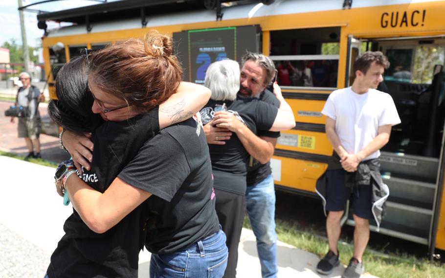 Left to Right, Patricia and Manuel Oliver, the parents of Joaquin “Guac” Oliver who was killed in the Parkland mass shooting, get hugs as they arrive at the Pulse memorial, as part of a 24-city summer school bus tour across the country to advocate for gun violence prevention on Monday, July 3, 2023.