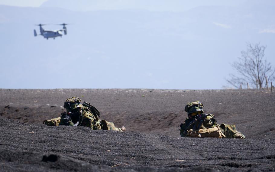 Japanese troops from 1st Amphibious Rapid Deployment Regiment secure a space for a U.S. Marine Corps MV-22 Osprey to land during a combined exercise in Japan on March 15, 2022. 
