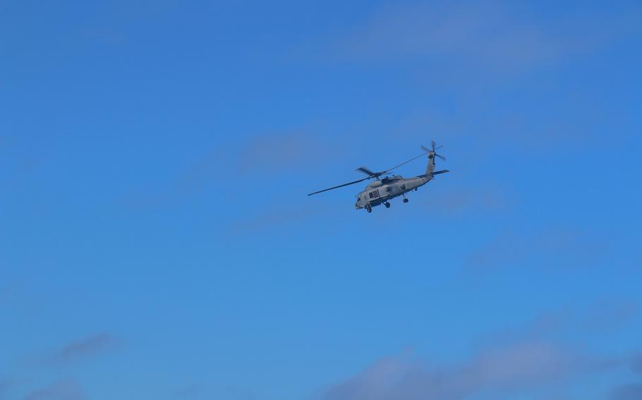 An MH-60R helicopter from the guided-missile destroyer HMAS Brisbane joins search-and-rescue efforts near Lindeman Island in Queensland, Australia, Saturday, July 29, 2023. 