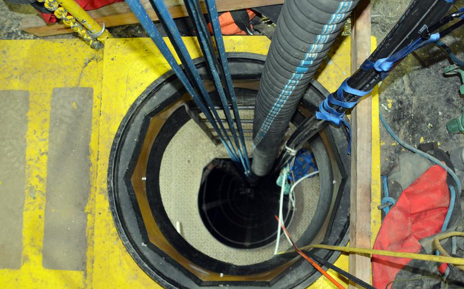 A black pipe leads out of the Red Hill well shaft in Honolulu, Hawaii, Friday, Jan. 28, 2022. It will carry petroleum-tainted water to a system of filters that will clean it.